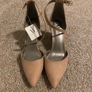 Nude closed toed pointed heels